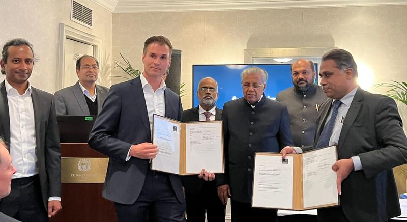 The signed and counterpart MoU displayed by representatives of the two Universities, with Professor Bhaskaran standing to the left