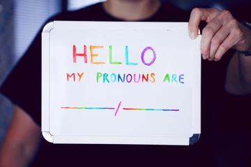 A noticeboard stating personal pronouns