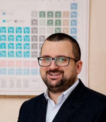 Prof David Armstrong  the periodic table is behind him