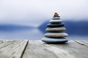 zen balancing pebbles misty lake